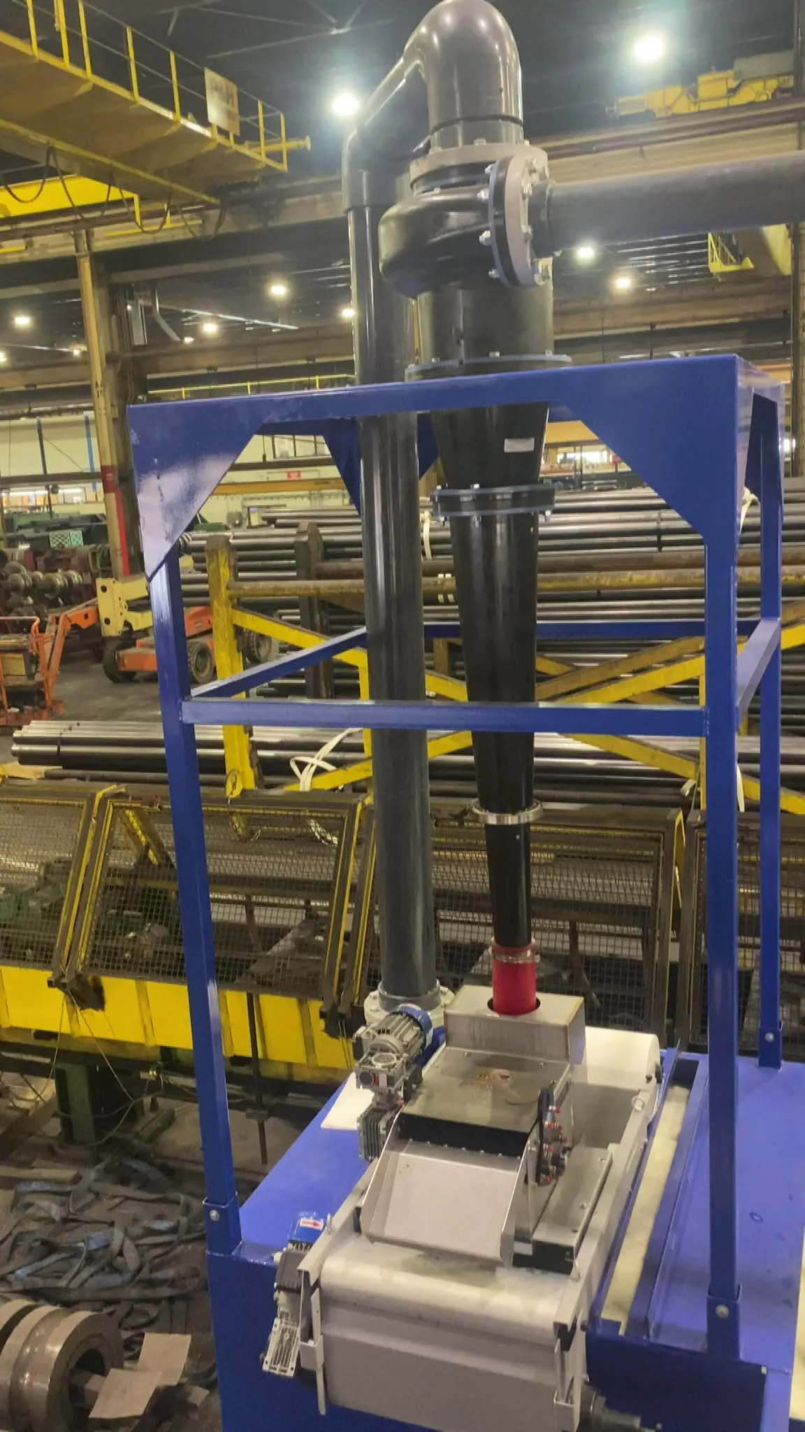Another view of blue EdjeTech separation equipment beside a tube mill production line