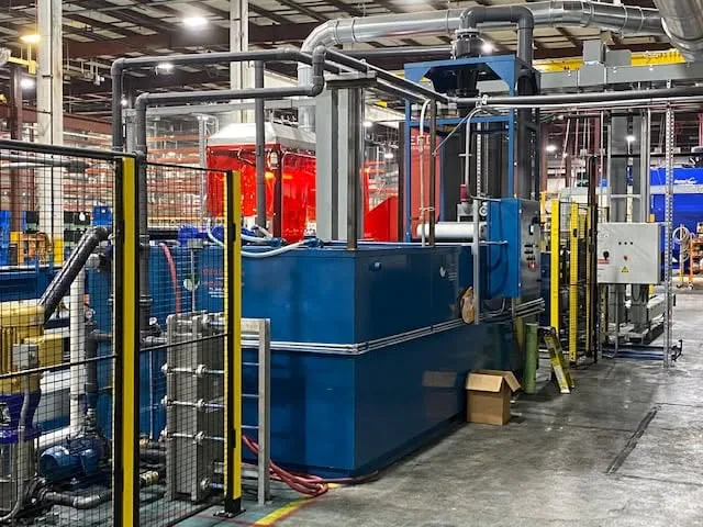 Blue EdjeTech coolant equipment positioned beside production machinery